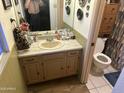 Modest bathroom with a sink, toilet, and vanity, offering functionality at 5735 N 32Nd Dr, Phoenix, AZ 85017