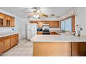 This sunny kitchen features wood cabinets, stainless steel appliances, and ample counter space for cooking at 5803 W John Cabot Rd, Glendale, AZ 85308