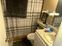 A compact bathroom with a shower/tub combo, neutral color palette, and functional fixtures at 61 W 11Th Dr, Mesa, AZ 85210