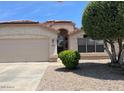 Attractive home exterior with tidy landscaping, an attached garage, and a welcoming entrance at 6376 W Adobe Dr, Glendale, AZ 85308