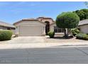 Charming single-story home featuring a manicured front lawn and attached garage at 6376 W Adobe Dr, Glendale, AZ 85308