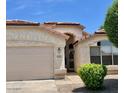 Inviting home exterior featuring a well-maintained front yard and attached garage at 6376 W Adobe Dr, Glendale, AZ 85308