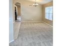 Neutral living room boasts vaulted ceilings, plush carpet flooring, and light beige walls, creating an inviting atmosphere at 6376 W Adobe Dr, Glendale, AZ 85308