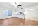Open-concept living area with hardwood floors and seamless flow into the breakfast bar at 9641 N 36Th Dr, Phoenix, AZ 85051