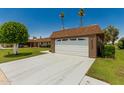 Spacious two-car garage with a large driveway, providing ample parking for residents and guests at 10022 W Mountain View Rd, Sun City, AZ 85351