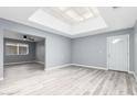 Bright, airy living room featuring new laminate flooring and abundant natural light at 10022 W Mountain View Rd, Sun City, AZ 85351