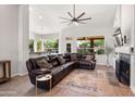 Spacious living room with hardwood floors, a fireplace, and comfortable seating at 11103 E Blue Sky Dr, Scottsdale, AZ 85262