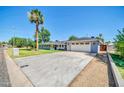 Single-Gathering home with a well-maintained yard, a two-car garage, and mature landscaping at 1208 E Tuckey Ln, Phoenix, AZ 85014