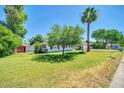 Inviting home with a spacious front yard, mature trees, and a charming water feature at 1208 E Tuckey Ln, Phoenix, AZ 85014