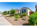 Charming single-story home with landscaped desert front yard and shutters, perfect for curb appeal and low-maintenance living at 12204 W Parkway Ln, Avondale, AZ 85323