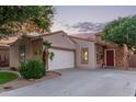 A well-kept single-Gathering home featuring a spacious driveway and attractive desert landscaping at 14864 W Riviera Dr, Surprise, AZ 85379