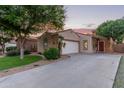Single-story home with desert landscaping, driveway, and covered entryway, blending charm and functionality at 14864 W Riviera Dr, Surprise, AZ 85379