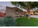 A well-manicured front yard leads to the home, complemented by mature landscaping and a welcoming atmosphere at 14864 W Riviera Dr, Surprise, AZ 85379