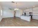 Spacious kitchen with white cabinets, granite counters, stainless appliances, and an open concept floorplan at 14870 W Encanto Blvd # 2006, Goodyear, AZ 85395