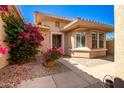 Cozy house featuring a tiled roof, desert landscaping and flowering plants at 16972 W Anasazi Ct, Surprise, AZ 85387