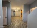 Open-concept living room featuring wood-look tile flooring, neutral paint, and recessed lighting at 1736 W Pollack St, Phoenix, AZ 85041