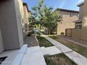 Side yard featuring a walkway and desert landscaping separating two homes at 1736 W Pollack St, Phoenix, AZ 85041