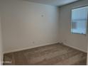 Bedroom features neutral carpeting, a window with blinds, and an electrical outlet at 18232 W La Senda Dr, Surprise, AZ 85387