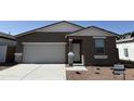 Front exterior of home with two-car garage and gravel landscaping at 18232 W La Senda Dr, Surprise, AZ 85387