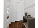 Bright entryway featuring wood flooring, white walls, and stylish decor at 20312 W Sells Dr, Buckeye, AZ 85396