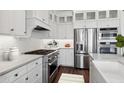 Modern kitchen showcasing stainless appliances, white cabinetry, and stylish backsplash at 20312 W Sells Dr, Buckeye, AZ 85396