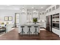 Bright kitchen with stainless appliances, sleek island, and elegant pendant lighting at 20312 W Sells Dr, Buckeye, AZ 85396