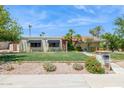 Charming single-story home with desert landscaping, grassy lawn, and quaint curb appeal at 2236 E Sierra St, Phoenix, AZ 85028