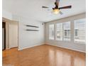 Bright living room with wood floors, ceiling fan and multiple windows offering lots of natural light at 2401 E Rio Salado Pkwy # 1047, Tempe, AZ 85288