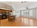 Open concept living room with wood floors, ceiling fan, and abundant natural light at 2401 E Rio Salado Pkwy # 1047, Tempe, AZ 85288