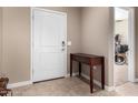 Inviting entryway with wood table decor and tile flooring at 30128 W Weldon Ave, Buckeye, AZ 85396