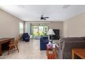 Comfortable living room with neutral colors, tiled floor, ceiling fan and natural light at 30128 W Weldon Ave, Buckeye, AZ 85396