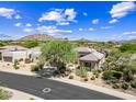 An aerial shot of the property and surrounding neighborhood with mountain views at 33317 N 71St St, Scottsdale, AZ 85266
