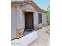 Inviting entryway with a charming front door and manicured landscaping at 42382 W Hillman Dr, Maricopa, AZ 85138