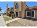 Desert townhome featuring stucco walls, red tile roof, and xeriscaped front yard at 4601 N 102Nd Ave # 1055, Phoenix, AZ 85037