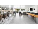 Open-concept living room boasts modern gray accents, stylish lighting, and indoor recreation area at 4633 N 49Th Pl, Phoenix, AZ 85018