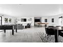 Expansive living area showcasing a modern aesthetic with recessed lights, game area, and comfortable seating at 4633 N 49Th Pl, Phoenix, AZ 85018