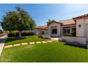Inviting single-story home with manicured lawn and step stone pathway leading to the entrance at 5517 W Aster Dr, Glendale, AZ 85304