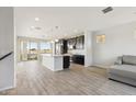 Large open kitchen with an island, granite countertops, stainless steel appliances, and access to a balcony at 663 W Flintlock Way, Chandler, AZ 85286