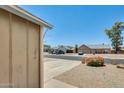 Neighborhood street view, featuring desert landscaping in the front and neighborhood homes at 6804 W Turquoise Ave, Peoria, AZ 85345