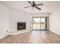 Bright living room with fireplace and sliding glass door to patio at 7061 E Broadway Rd # 48, Mesa, AZ 85208