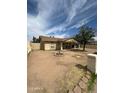 Quaint single-story home featuring a spacious front yard with minimal landscaping and neutral toned exterior at 1045 S Solomon St, Mesa, AZ 85204