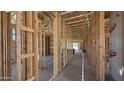 Unfinished home interior with wooden framework showcasing open layout and potential for personalized design at 11338 E Utah Ave, Mesa, AZ 85212