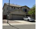 Two-story home with a two-car garage and a low-maintenance desert landscape at 11633 W Jefferson St, Avondale, AZ 85323