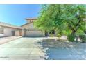 Inviting single-story home boasts a two-car garage, complemented by low-maintenance desert landscaping at 11633 W Jefferson St, Avondale, AZ 85323