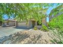 Desirable two-story home featuring a two-car garage, tidy landscaping, and a cozy front porch at 11633 W Jefferson St, Avondale, AZ 85323