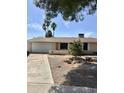 Single-story home with desert landscaping, a driveway, attached garage, and a welcoming front entrance at 1304 E Hackamore St, Mesa, AZ 85203