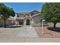 Charming two-story home with a well-maintained front yard and desert landscaping at 15040 W Windrose Dr, Surprise, AZ 85379