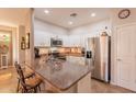 Well-equipped kitchen with granite countertops, stainless steel appliances, and breakfast bar at 1552 E Manor Dr, Casa Grande, AZ 85122