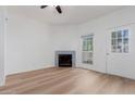 Bright living room with wood floors, fireplace, and a ceiling fan at 1600 N Saba St # 151, Chandler, AZ 85225