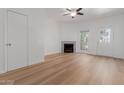Open living room featuring wood-style flooring, fireplace, and a bright window at 1600 N Saba St # 151, Chandler, AZ 85225